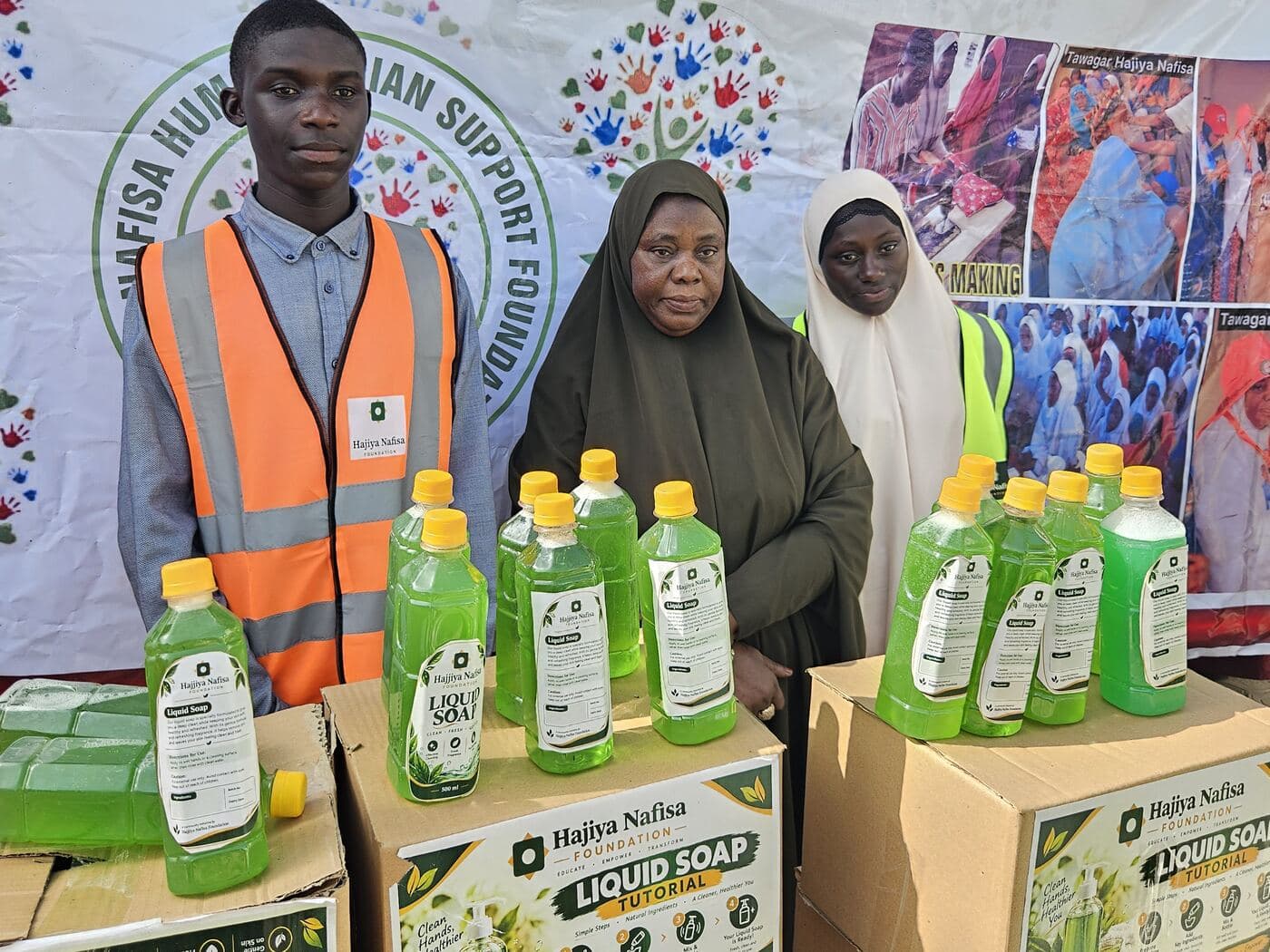 Hajiya Nafisa Umar, centre, with two of the foundation's volunteers behind liquid soap made through its empowerment programme in Kaduna